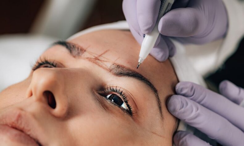 A beautician performs precise microblading on a client's eyebrows in a salon. - Photo by Roberto Colatosti on Pexels